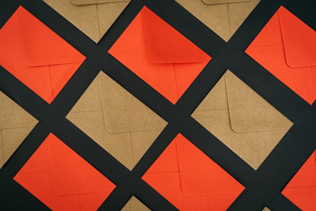 Orange and khaki colored envelopes in a grid pattern. 